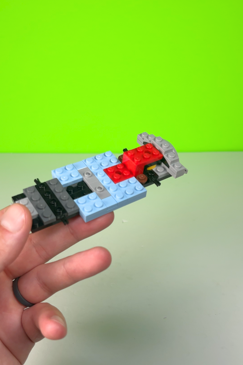 Partially built chassis with red, black, blue, and grey colored blocks.