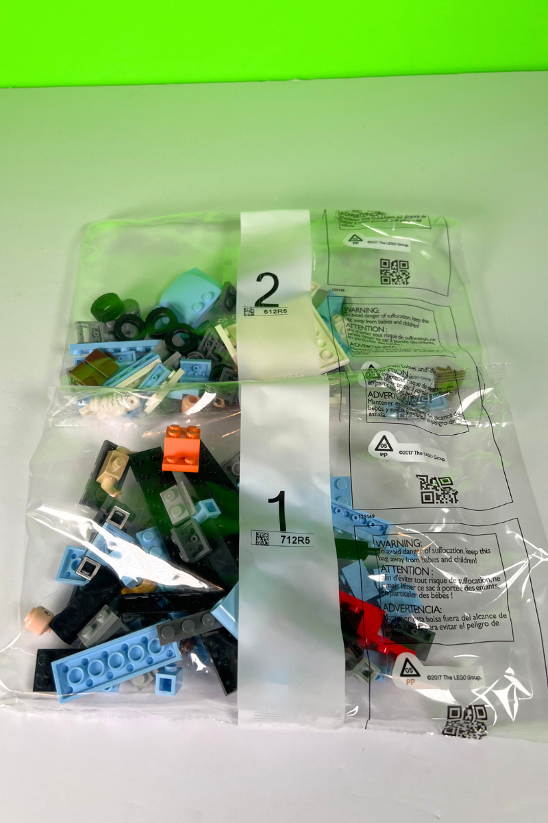 Two plastic bags filled with LEGO pieces