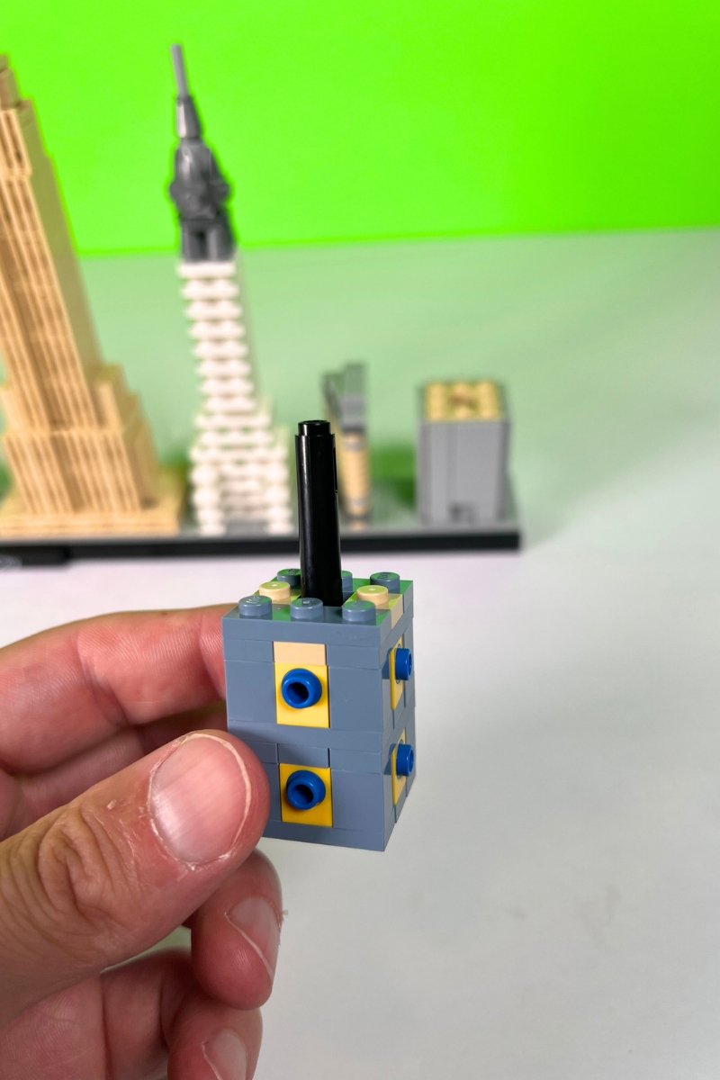 Small stack of LEGO bricks with a black cylinder in the center